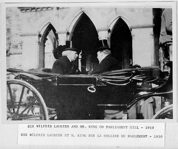 A couple of men in a carriage

Description automatically generated