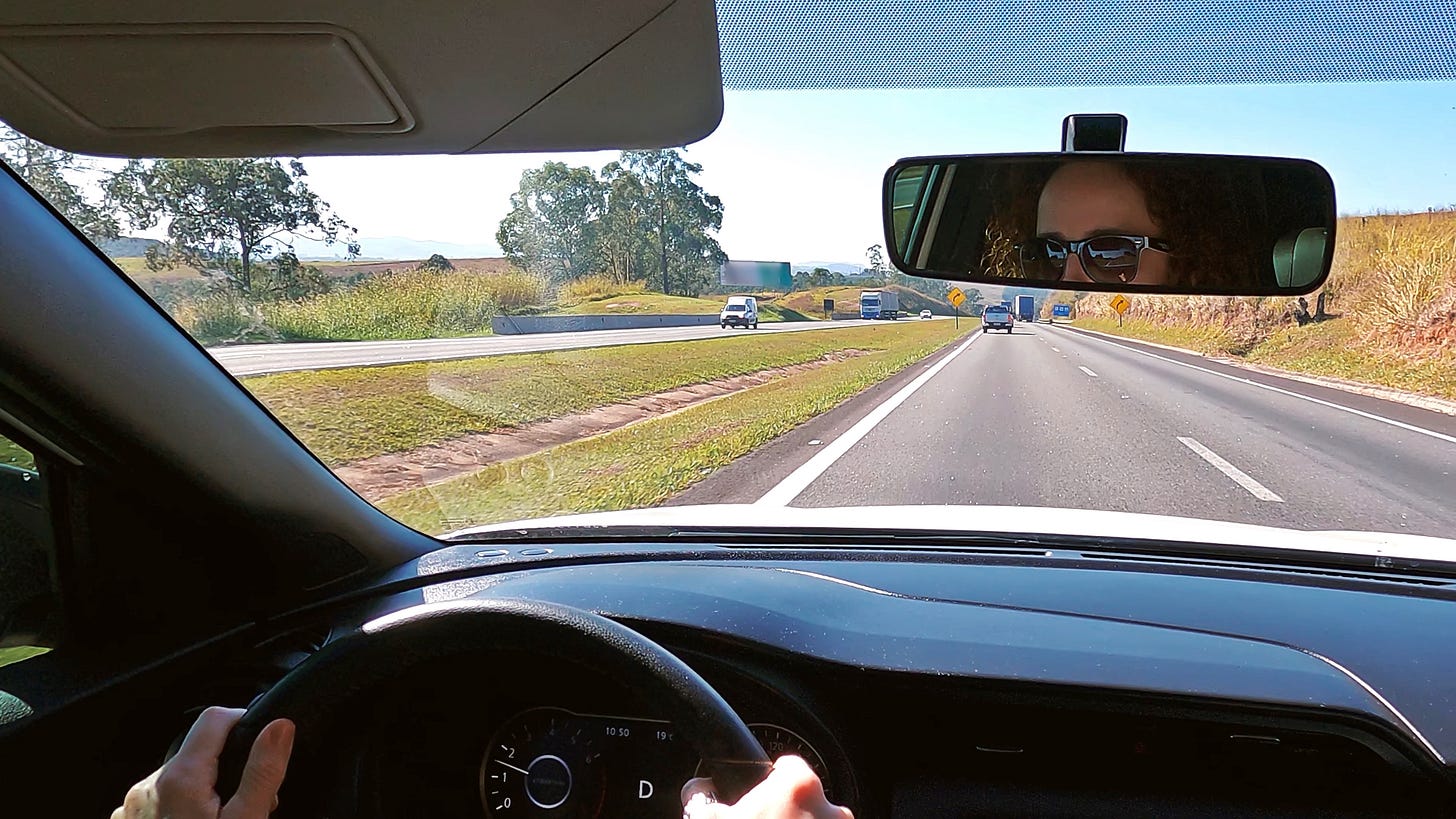 A woman drives down the highway. A woman drives down the highway.