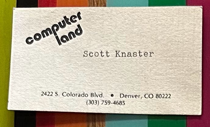 A business card for ComputerLand of Denver with "Scott Knaster" typed on a typewriter.