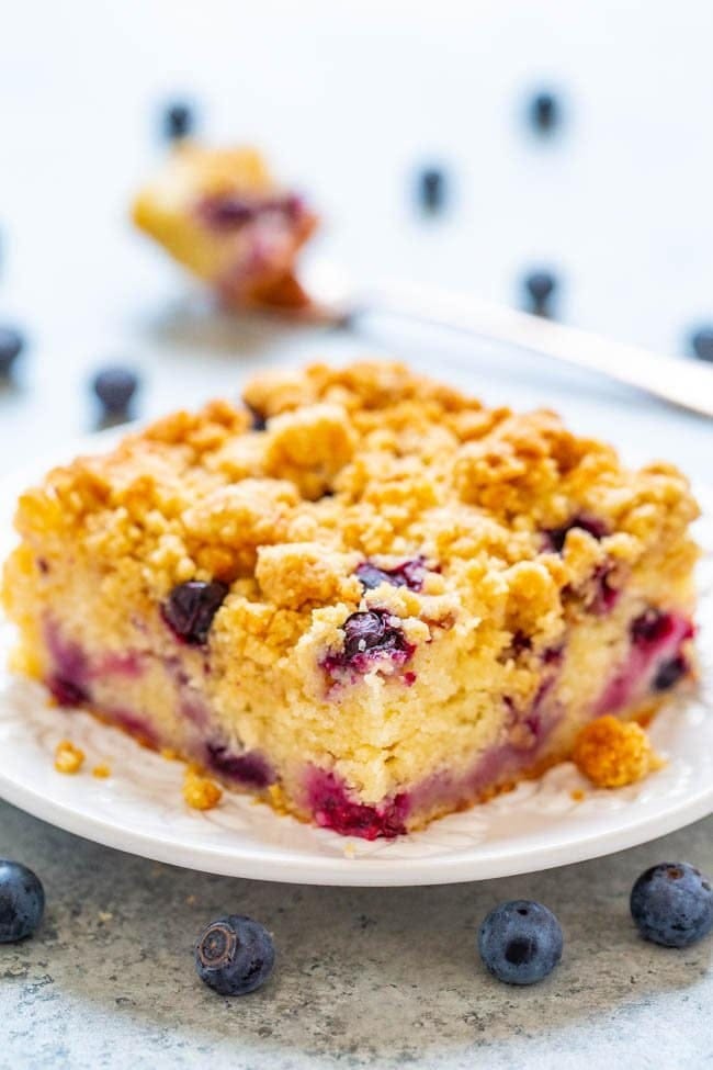 A slice of Blueberry Streusel Coffee Cake on a plate. A slice of Blueberry Streusel Coffee Cake on a plate.