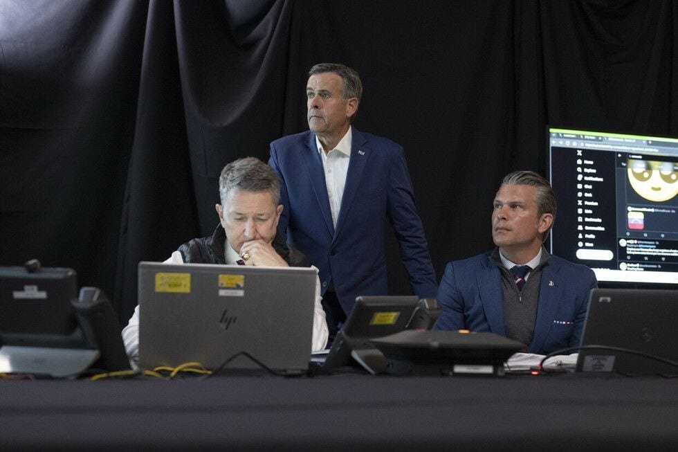 May be an image of television, suit and newsroom