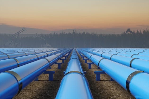 Blue Pipeline Infrastructure at Sunset in Industrial Oil Field Blue Pipeline Infrastructure at Sunset in Industrial Oil Field