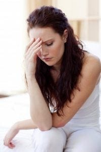 a sad woman holding her head in her hands