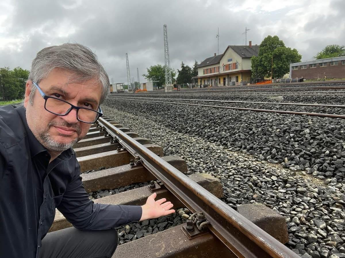 May be an image of train and railroad
