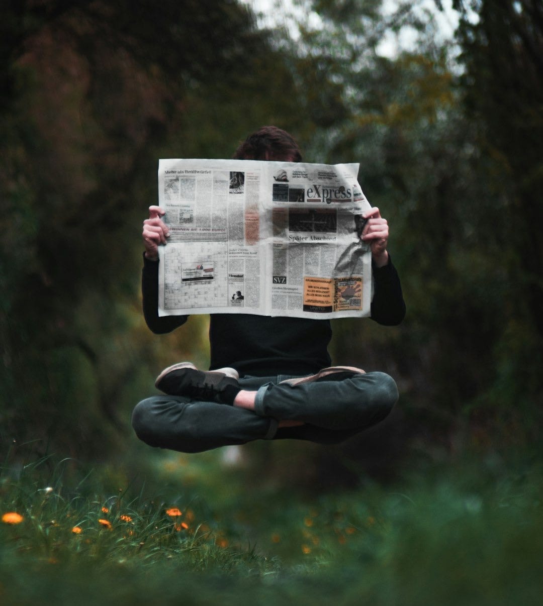 person holding a news paper during daytime person holding a news paper during daytime