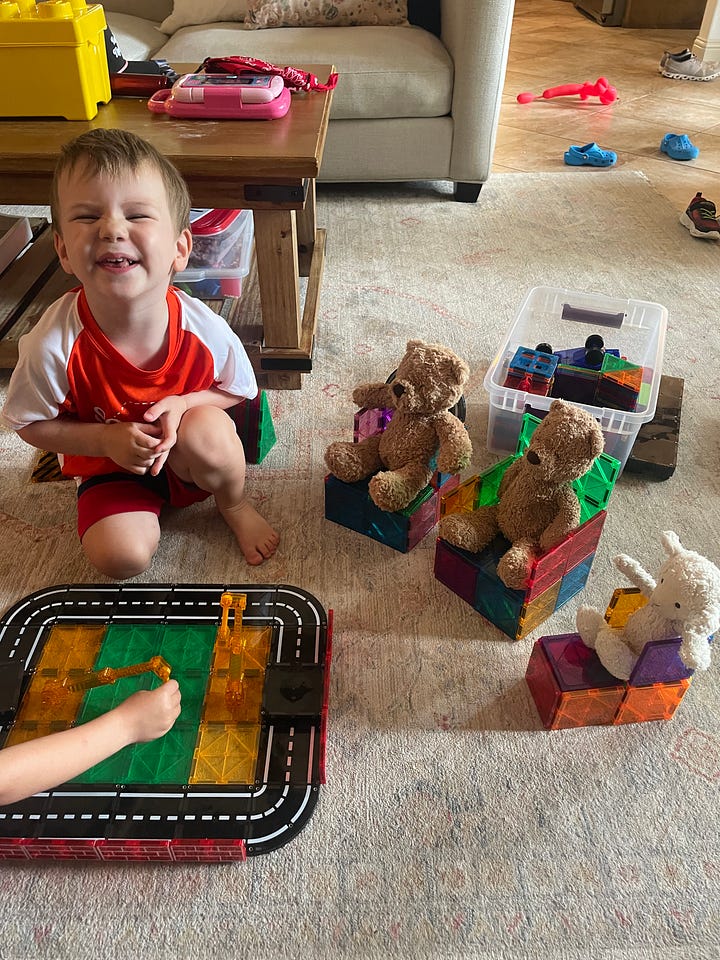 A boy on the left smiling in front of magnetic tiles with his teddy bears, and a boy on the right eating a chocolate ice cream with sprinkles