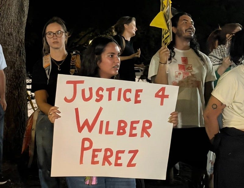 Protester holding sign: "Justice for Wilber Perez" Protester holding sign: "Justice for Wilber Perez"