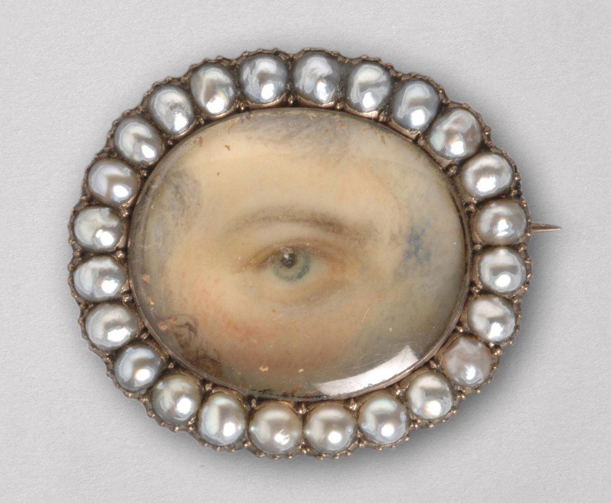 Broach pin circa 1790s-1810. Example of a "Lovers' Eye" miniature; watercolor on ivory, surrounded by pearls.
