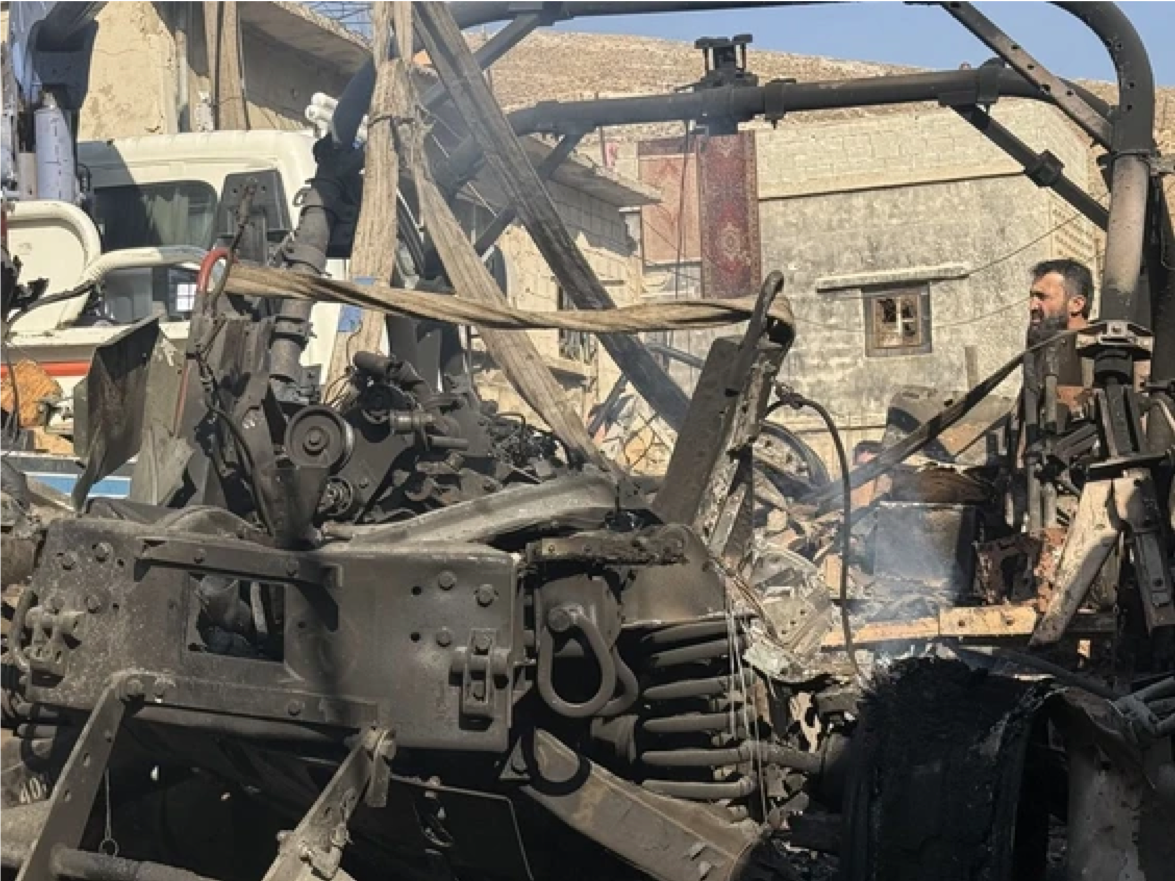 A crane removes a burnt Israeli Humvee from a street in the southern Syrian village of Beit Jin on November 28, 2025. Photo by - /AFP via Getty Images