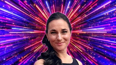 A woman with dark hair tied back smiles to camera, set against a backdrop of glittering pink, blue and purple rays of light A woman with dark hair tied back smiles to camera, set against a backdrop of glittering pink, blue and purple rays of light