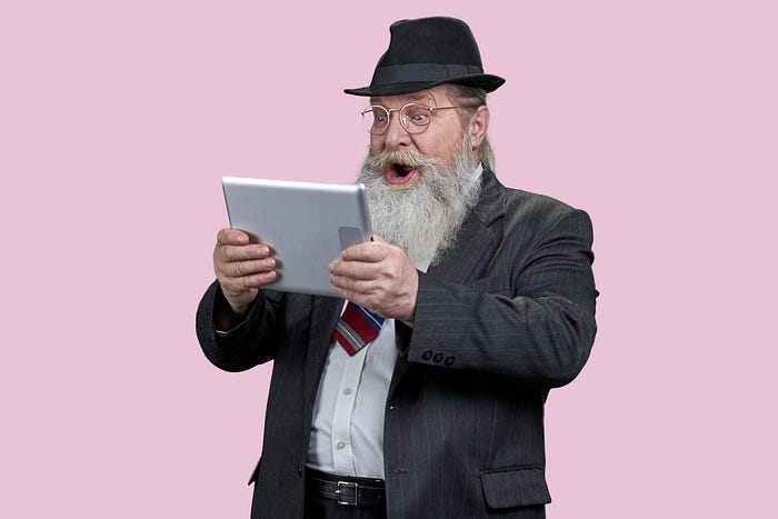 Portrait of shocked aged man with tablet pc. Portrait of shocked aged man with tablet pc.