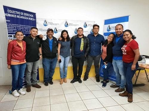 A group of people posing for a photo

Description automatically generated