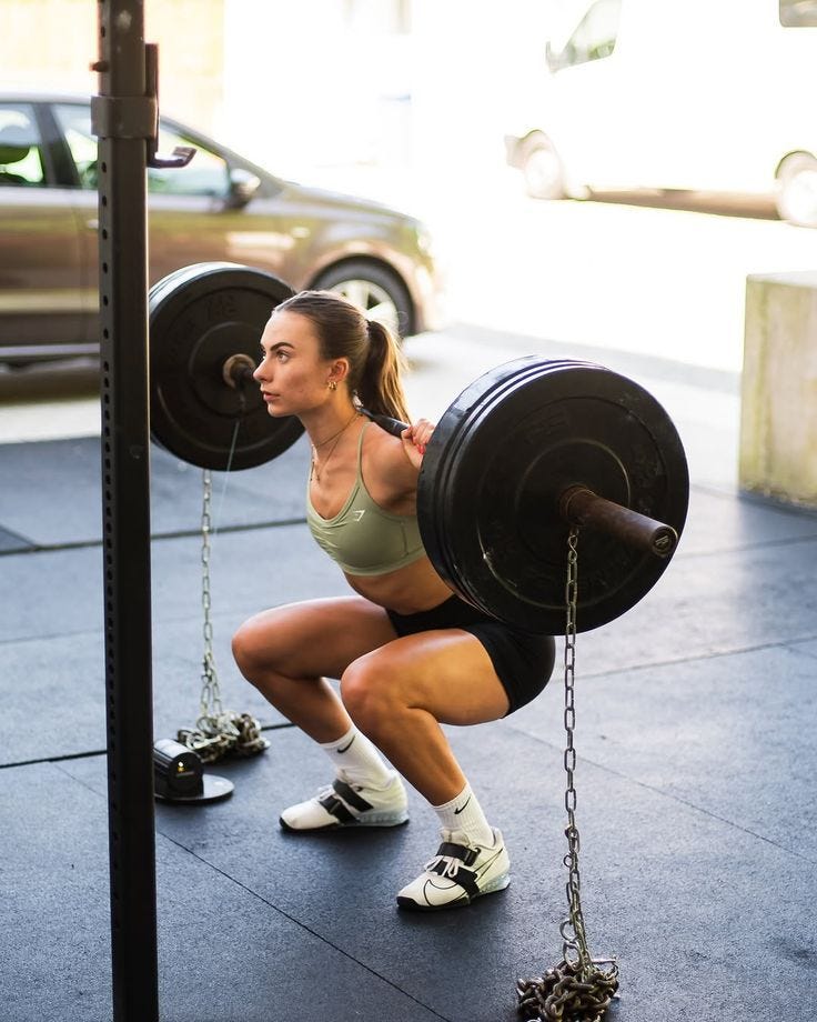 Strong woman squatting with chains. Strong woman squatting with chains.