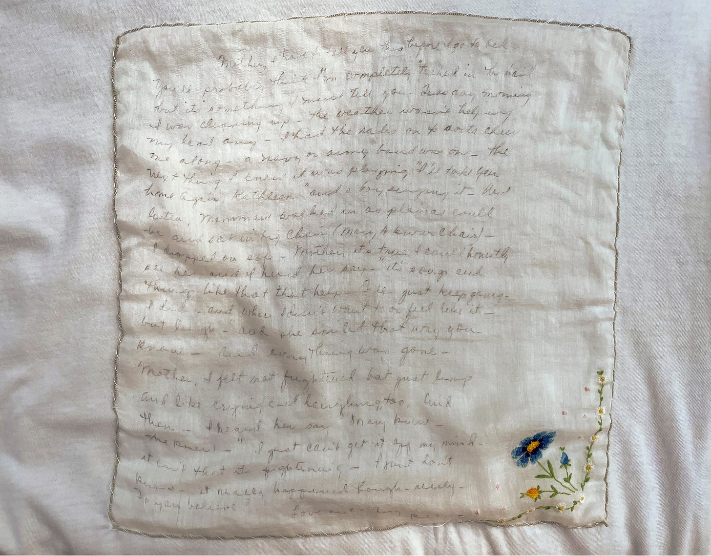 Text transcribed with ballpoint onto a linen handkerchief and sewn to a white worn t-shirt