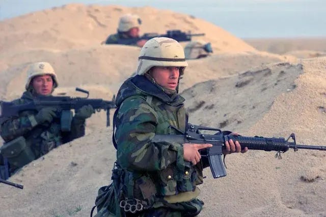 Marines from 'E' Company, 15th Marine Expeditionary Unit, near Az Zubayr during Operation Iraqi Freedom on March 23, 2003. Marines from 'E' Company, 15th Marine Expeditionary Unit, near Az Zubayr during Operation Iraqi Freedom on March 23, 2003.
