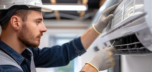 Handsome young hvac technician in blue cap repairing or installing ... Handsome young hvac technician in blue cap repairing or installing ...