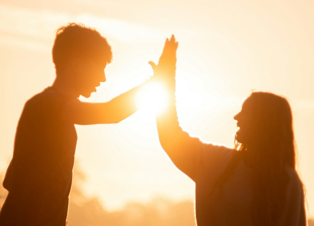 silhouette of man and woman holding hands during sunset silhouette of man and woman holding hands during sunset
