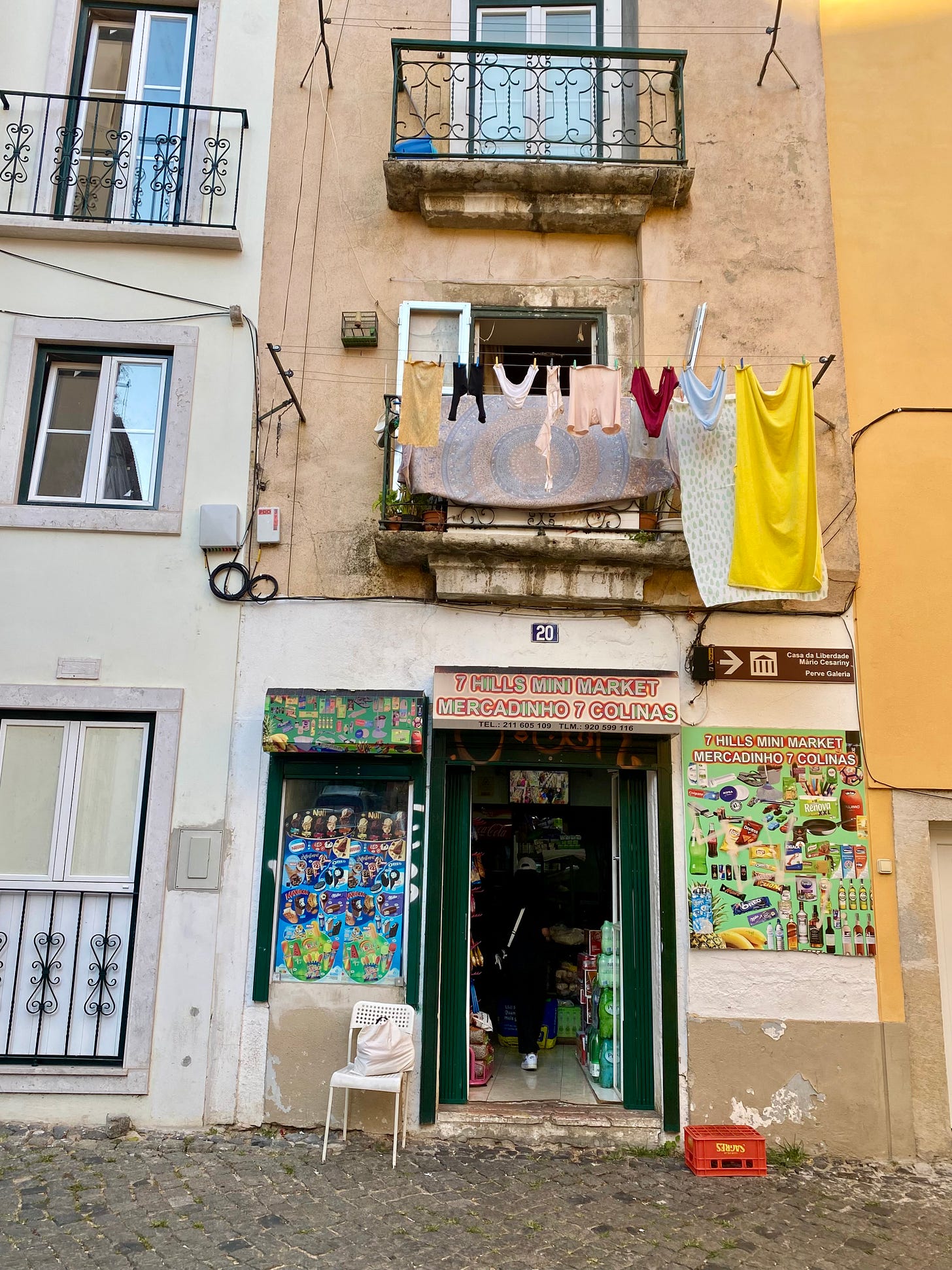 A balcony in Lisboa with washing hanging on a line.