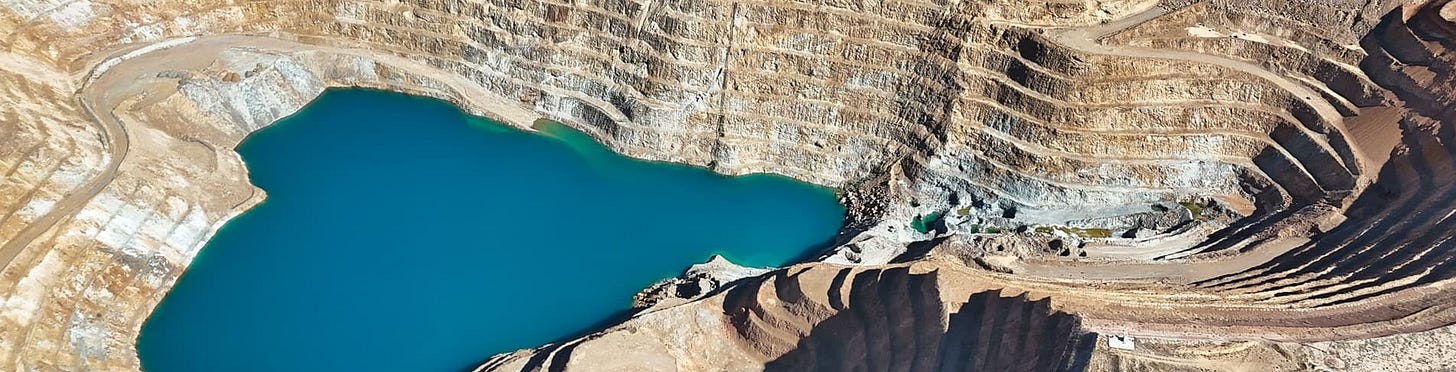 Aerial view of a large open-pit gold mine. Aerial view of a large open-pit gold mine.