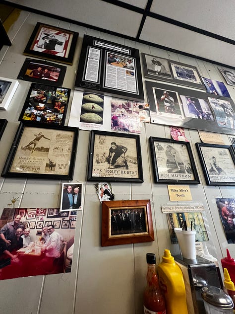 the Mike Slive table plaque, pictures of football players on a diner wall