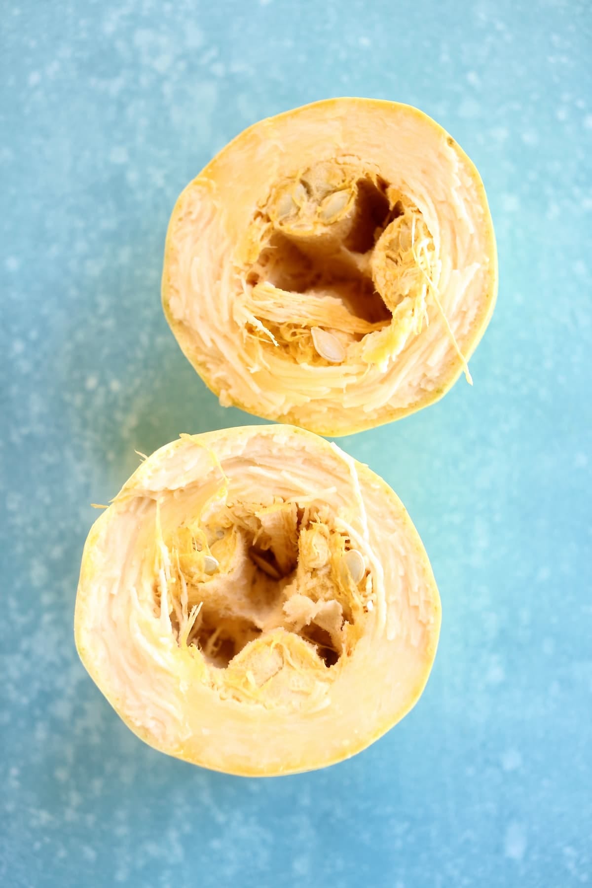 a close up of two squash on a blue table.