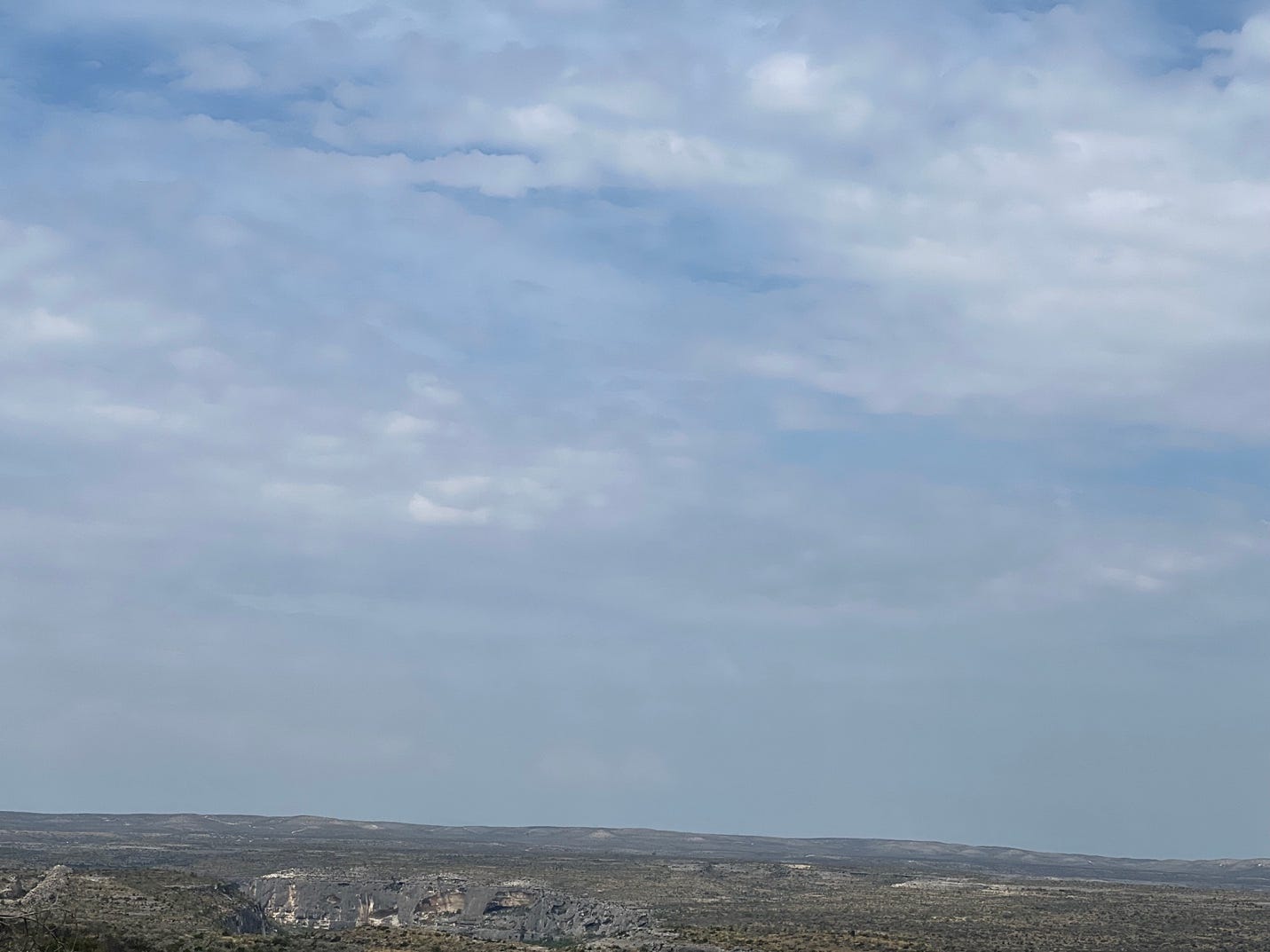 A landscape with a blue sky and clouds

Description automatically generated