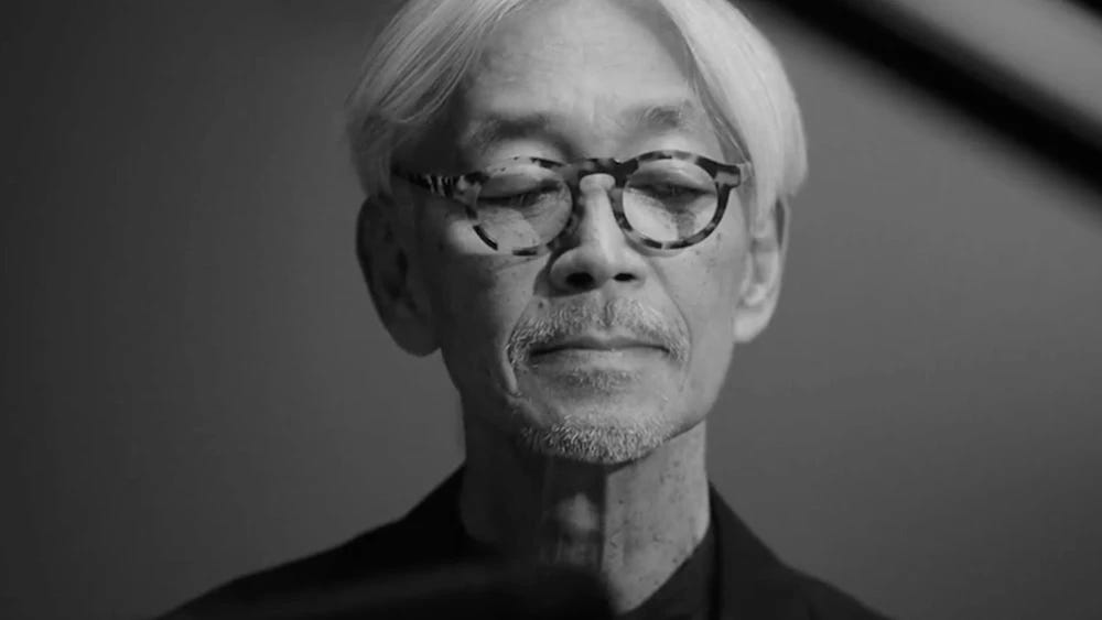Black and white still of Ryuichi Sakamoto