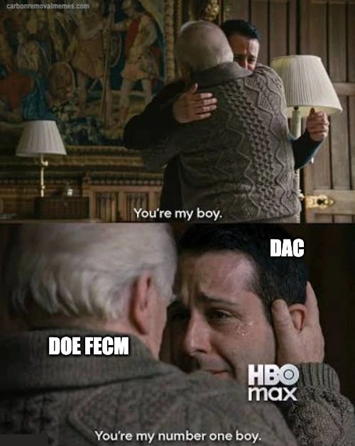 Two stacked panels from a television drama. In the first, a younger man in a suit embraces an older bald man in a cable-knit sweater, captioned "You’re my boy." In the second the older man, labeled "DOE FECM", holds the face of the younger man, labeled "DAC", who is crying, captioned "You’re my number one boy."