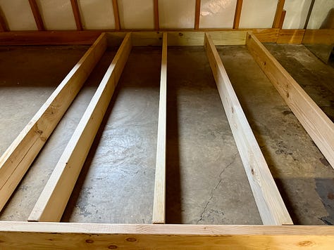 Photo mosaic of stud walls and bulkheads being built and placed.