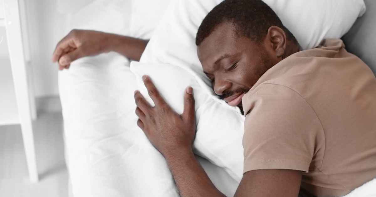man sleeping in bed