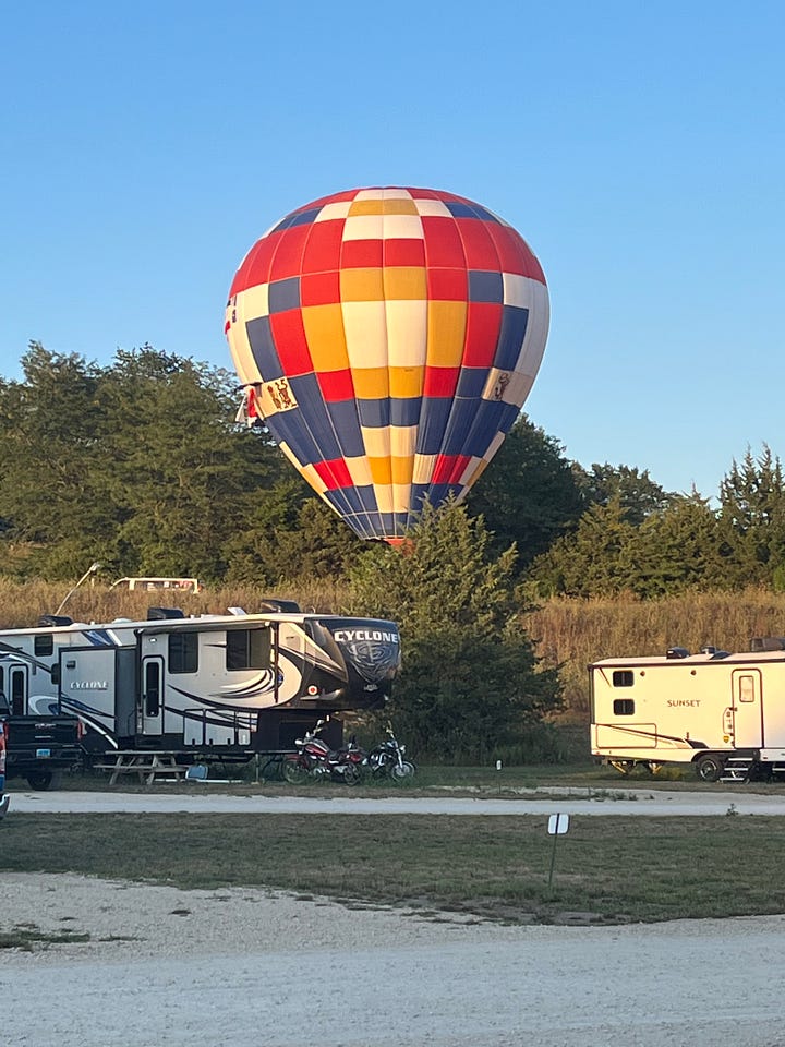 Our campsite and a hot air balloon at Crow's Nest RV Resort in Indianola, Iowa