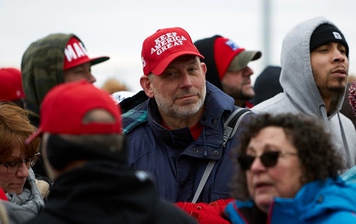 group of people in red cap and blue jacket group of people in red cap and blue jacket