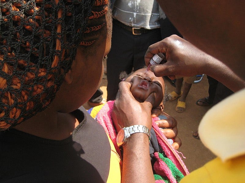 File:A young child receives oral polio vaccine dose (34692992936).jpg