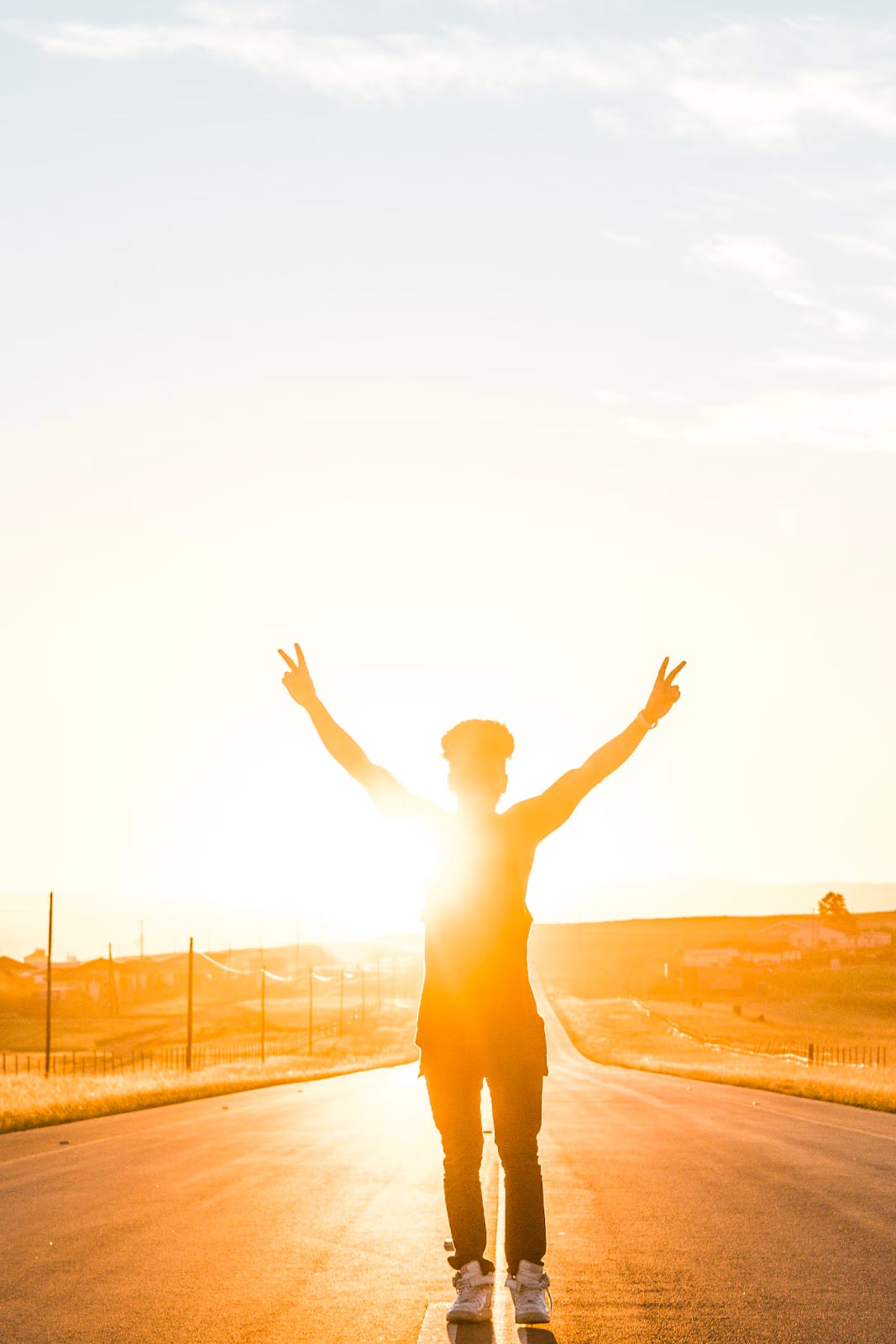 Person standing with hands raised in triumph