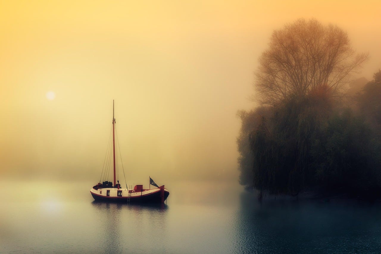small boat stopped on a misty lake in golden tones (cure for writers block) small boat stopped on a misty lake in golden tones (cure for writers block)