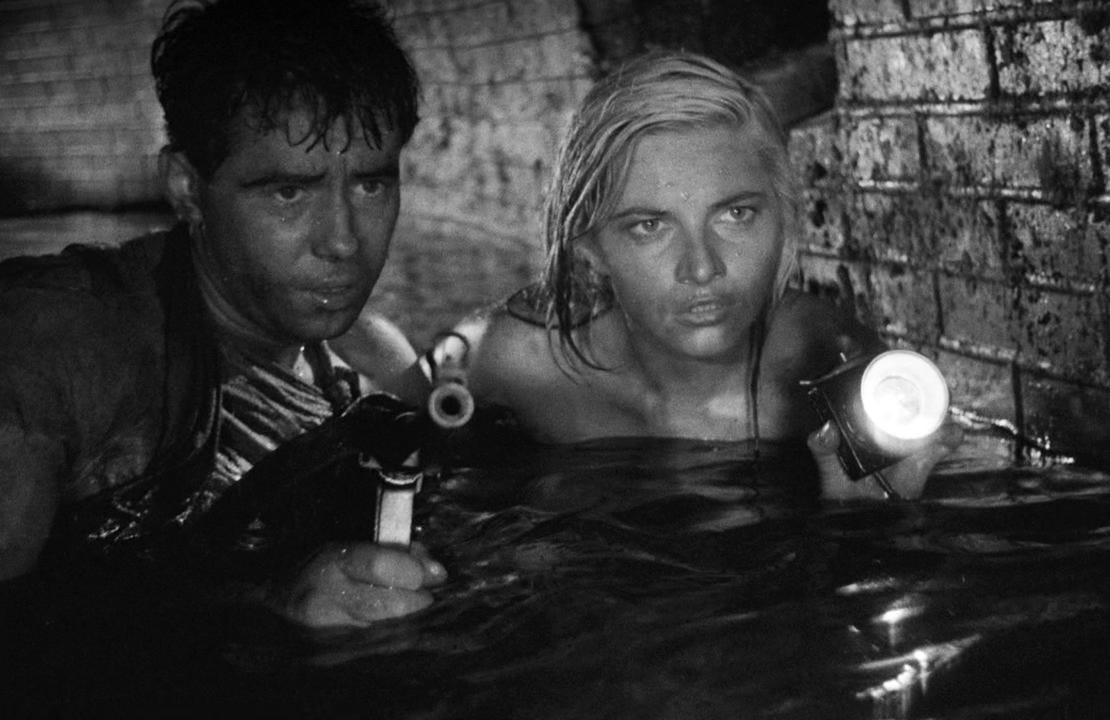 Korab (Tadeusz Janczar) and Stokrotka (Teresa Iżewska), up to their chests in the water.