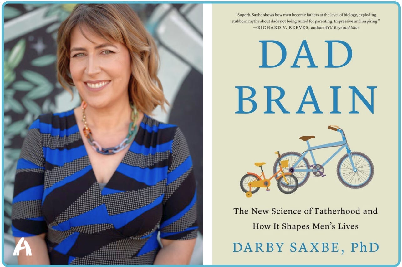 A promotional image showing author Darby Saxbe, PhD, on the left — a smiling woman with short sandy hair wearing a blue-and-black striped dress and colorful necklace — alongside the cover of her book Dad Brain: The New Science of Fatherhood and How It Shapes Men's Lives, which features an illustration of a large blue bicycle next to a small child's bicycle with training wheels. A promotional image showing author Darby Saxbe, PhD, on the left — a smiling woman with short sandy hair wearing a blue-and-black striped dress and colorful necklace — alongside the cover of her book Dad Brain: The New Science of Fatherhood and How It Shapes Men's Lives, which features an illustration of a large blue bicycle next to a small child's bicycle with training wheels.