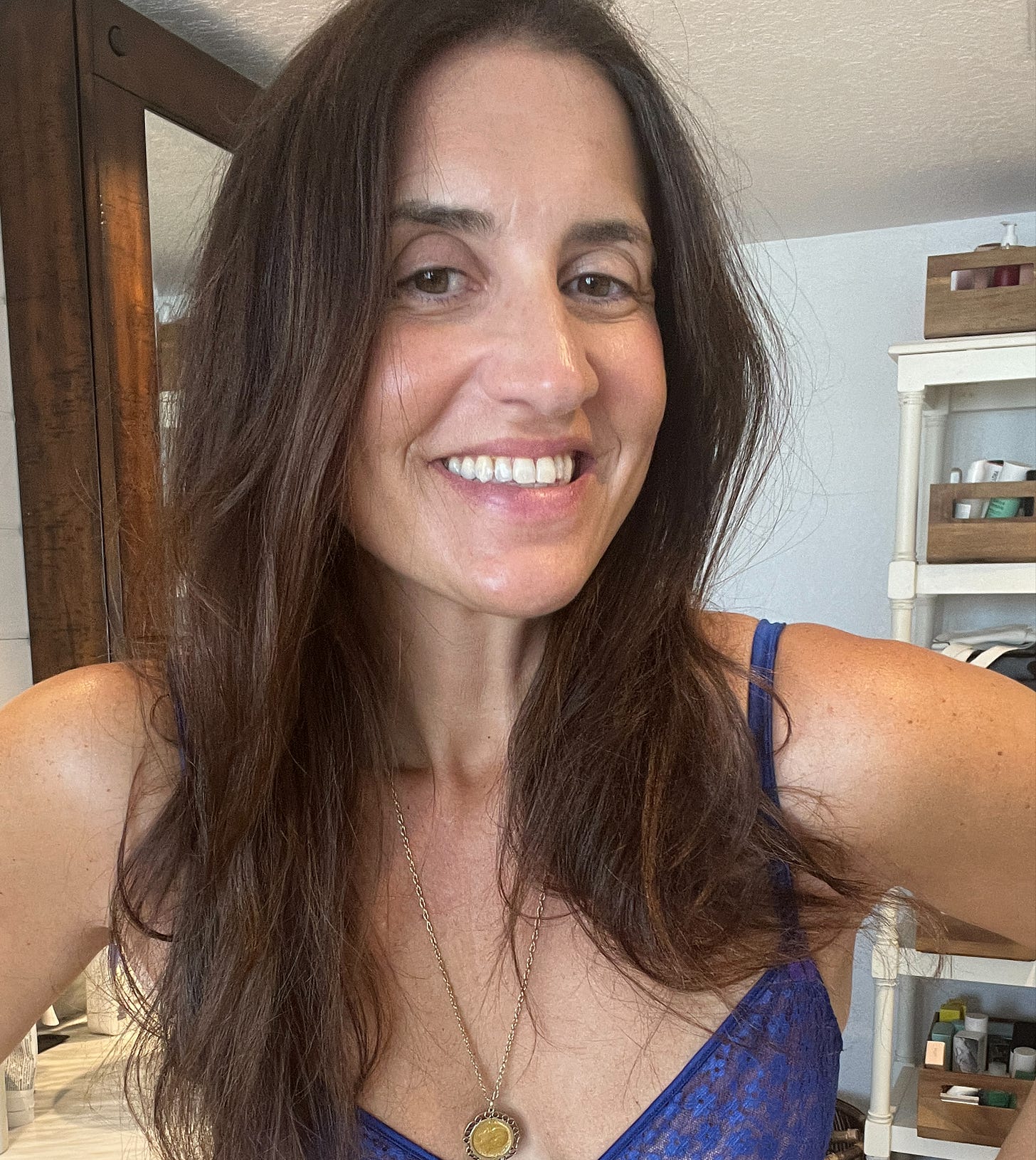 Close-up smiling selfie of a woman with long, healthy brown hair. Close-up smiling selfie of a woman with long, healthy brown hair.