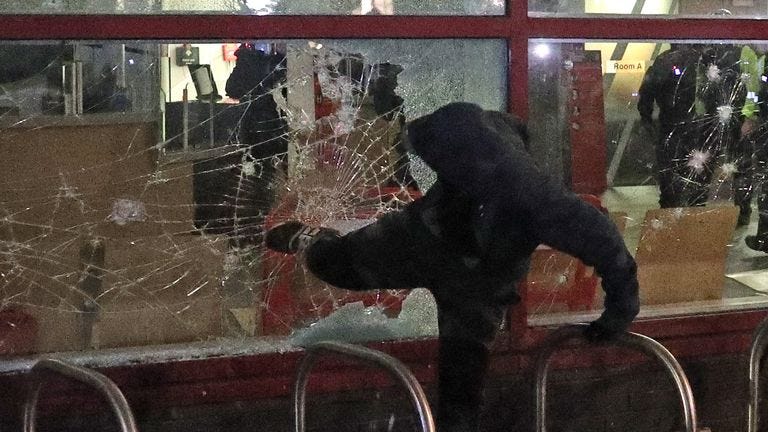 Protester kicks a smashed Bridewell Police Station window, as they take part in a 'Kill the Bill' protest in Bristol, demonstrating against the Government's controversial Police and Crime Bill. Picture date: Sunday March 21, 2021.