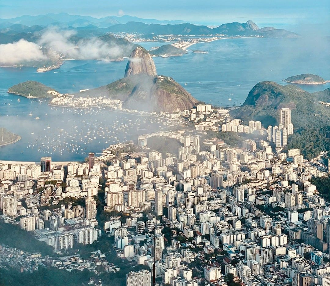 a city with a body of water in the background