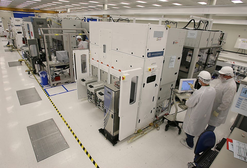 Applied Materials staffers work at the company's Austin facility in this file photo from 2007.  Applied Materials, which employs about 2,500 people in Austin, is considering a site in Hutto for a new $2 billion facility that could employ up to 800 people.