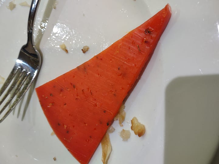 The photo gallery shows four pictures in a square. The top left picture is of a pita with a sour cream sauce and sausage meet. The top right image is of a sweets shop with Turkish and Bosnian sweets. The bottom left is of a wedge slice of green colored cheese and the bottom right is of a red colored wedge shaped slice of cheese.