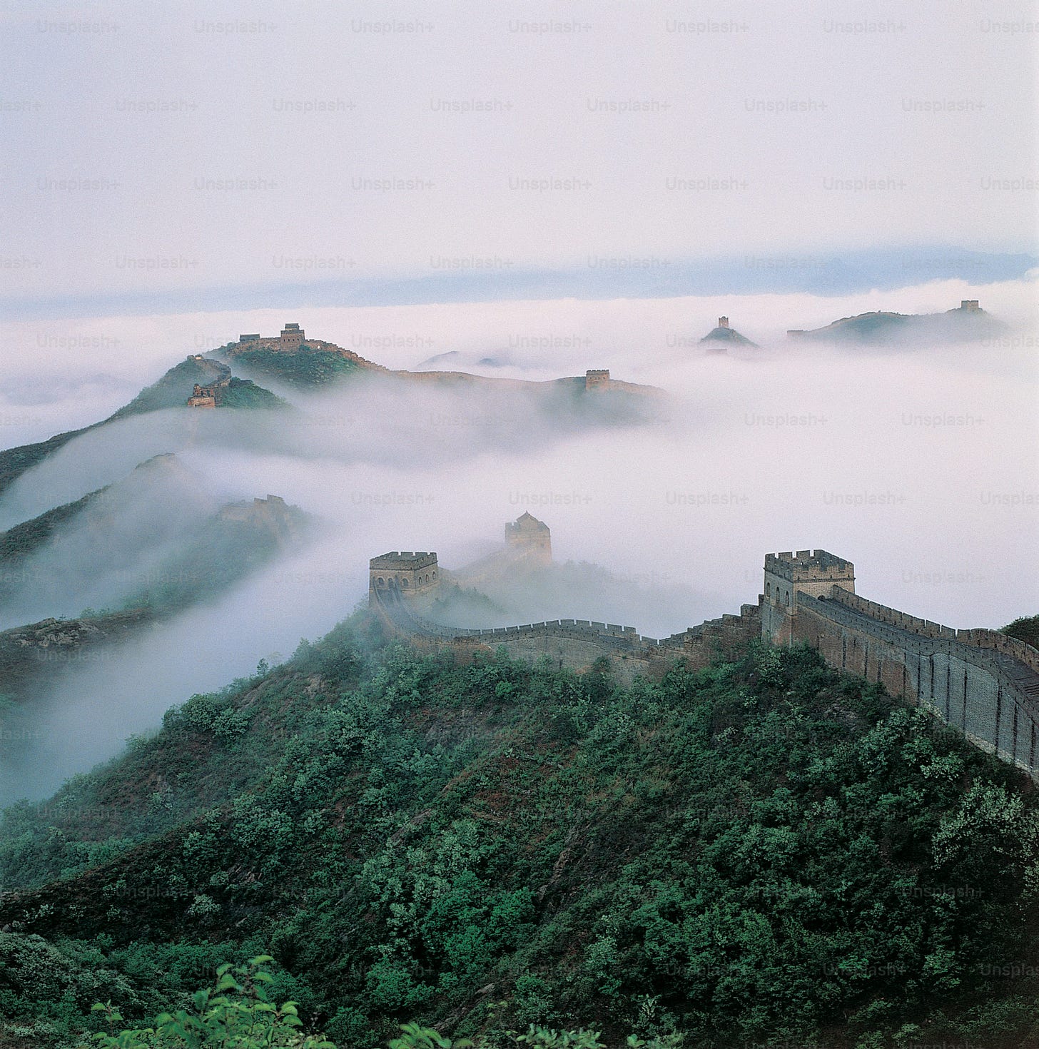 a view of the great wall of china in the fog a view of the great wall of china in the fog