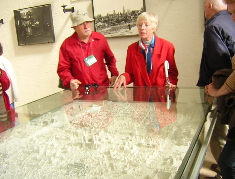 A person and person looking at a model of a city

AI-generated content may be incorrect.