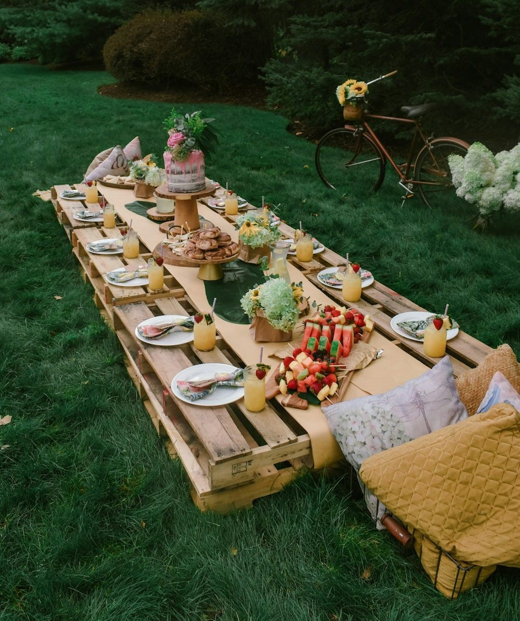 brown wooden picnic table on green grass field during daytime brown wooden picnic table on green grass field during daytime