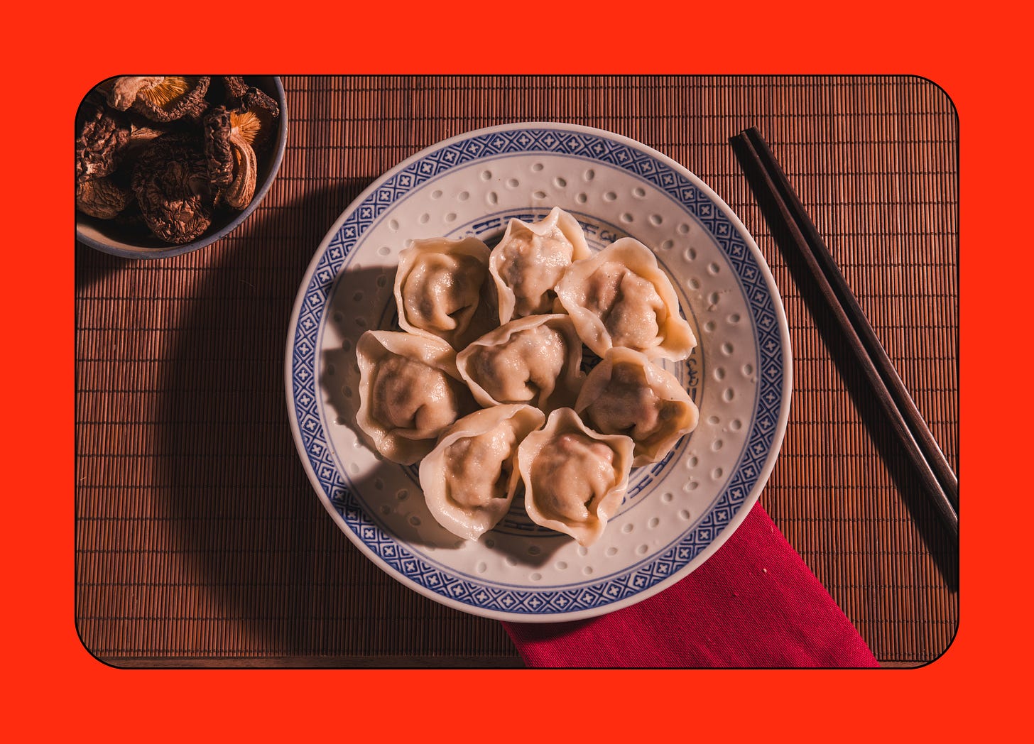 Overhead view of boiled chicken dumplings on a blue and white plate