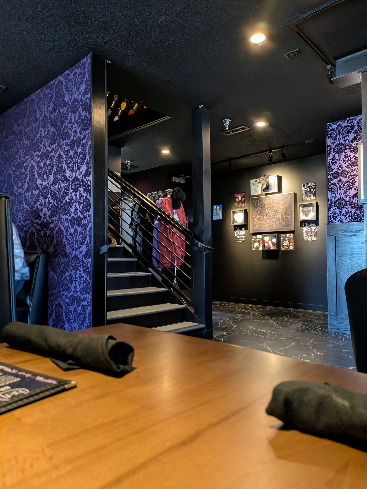 Interior of a restaurant with purple goth fleur wallpaper