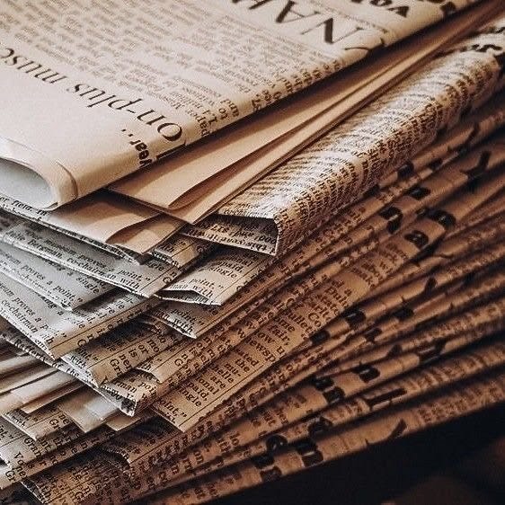This may contain: a stack of newspapers stacked on top of each other This may contain: a stack of newspapers stacked on top of each other