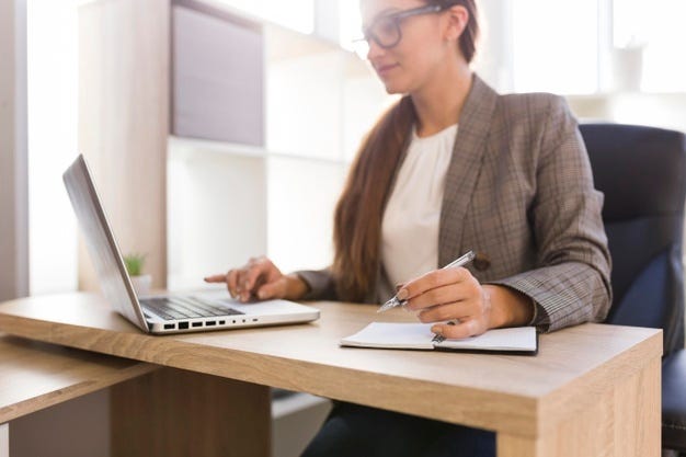 Mulher de negócios trabalhando em um laptop em seu escritório Foto gratuita