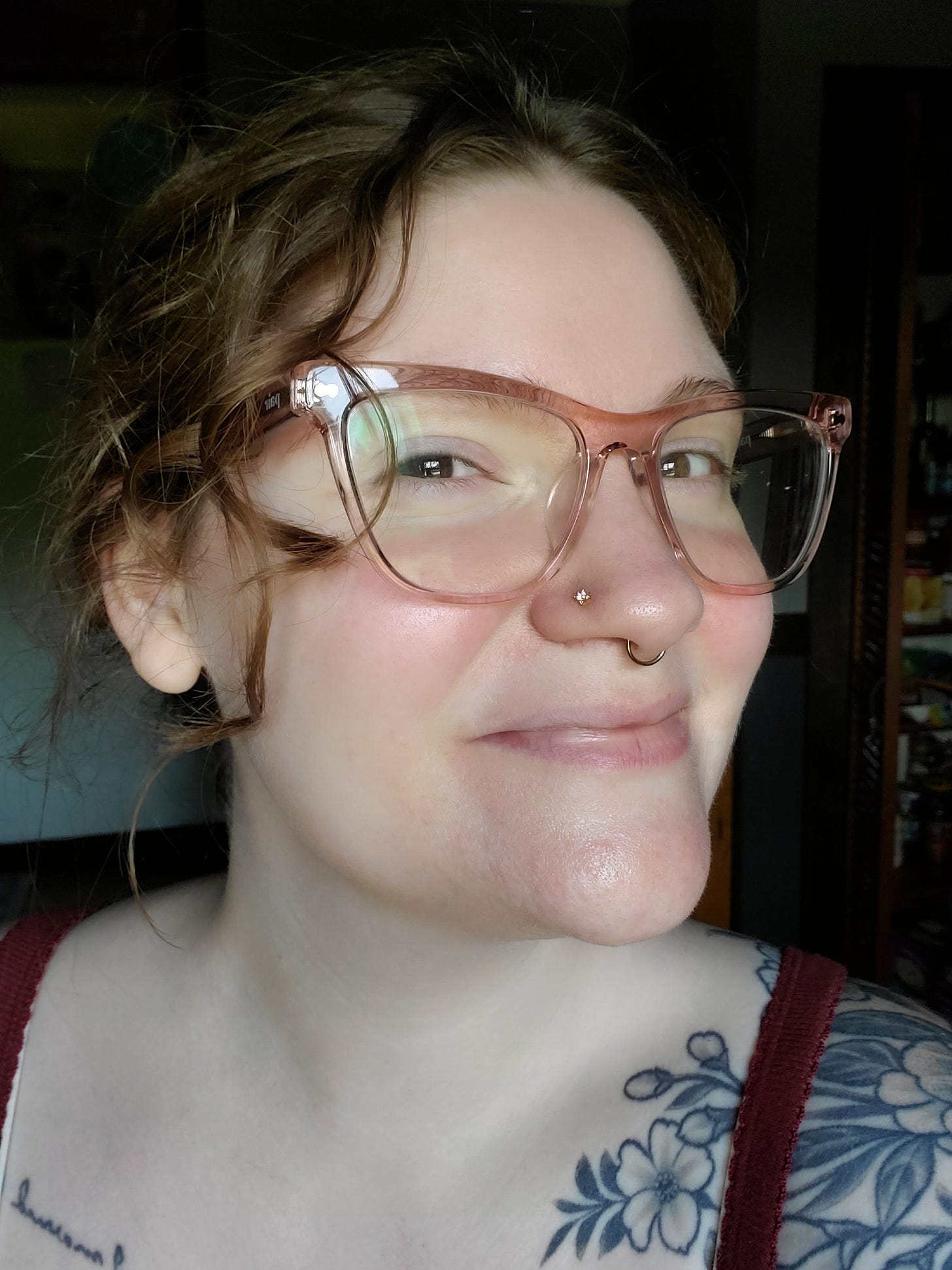 August smiles at the camera with head tilted slightly to the side to show the new nose ring (a small gold stud with a cubic zirconia inside).